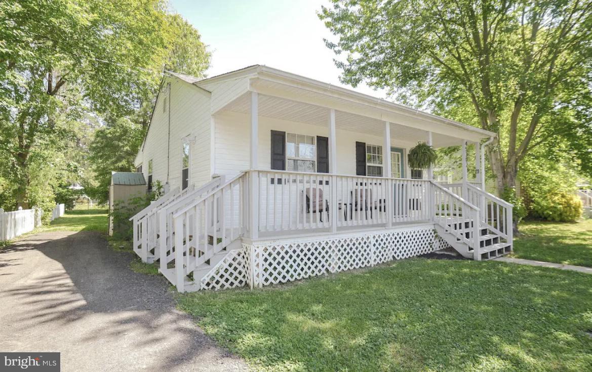 a view of a house with a yard and deck