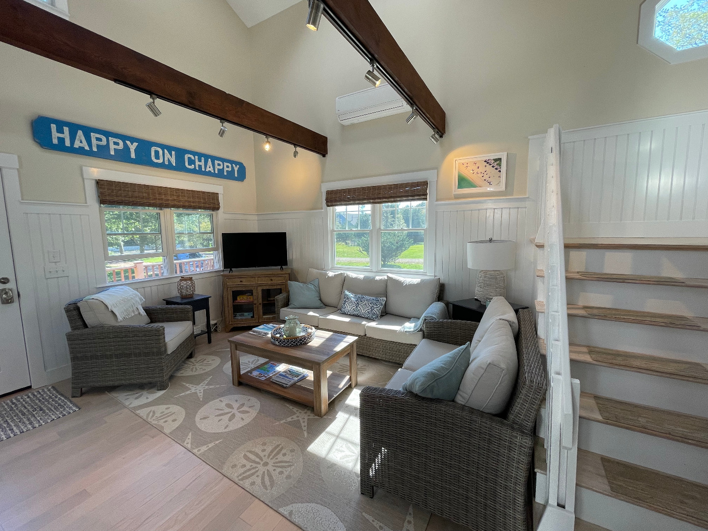 300 Chappaquiddick Road Edgartown, MA 02539 - Photo 11 of 16 a living room with furniture a large window and a flat screen tv
