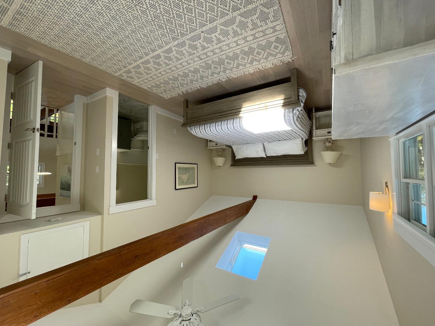 300 Chappaquiddick Road Edgartown, MA 02539 - Photo 14 of 16 a spacious bedroom with a bed and a chandelier