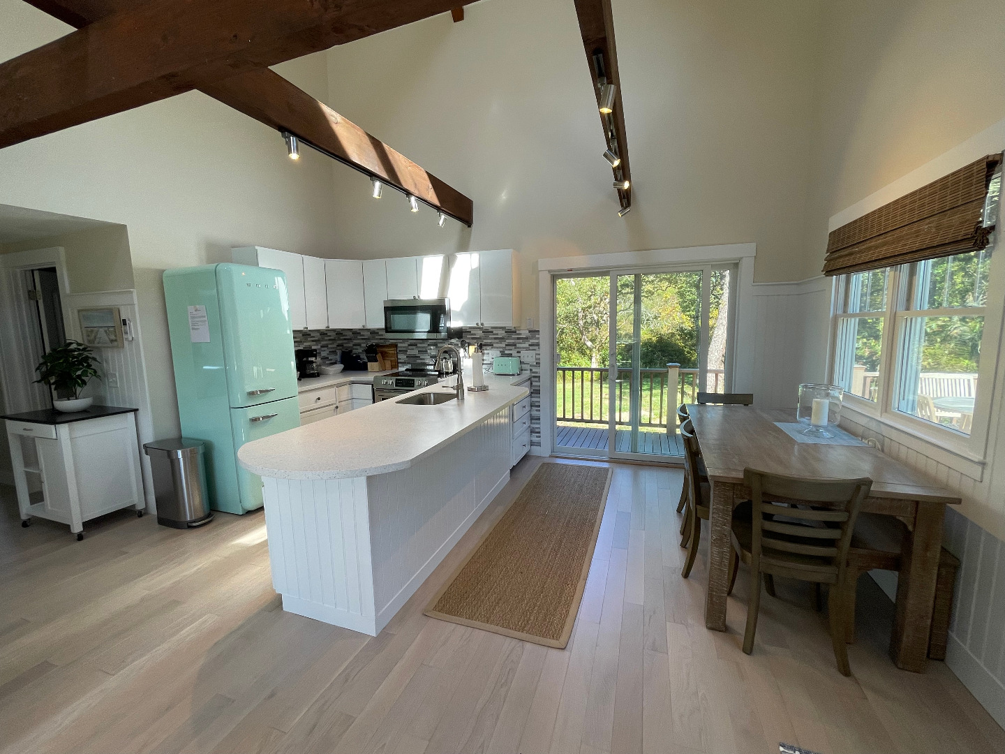 300 Chappaquiddick Road Edgartown, MA 02539 - Photo 4 of 16 a large kitchen with a table and chairs in it