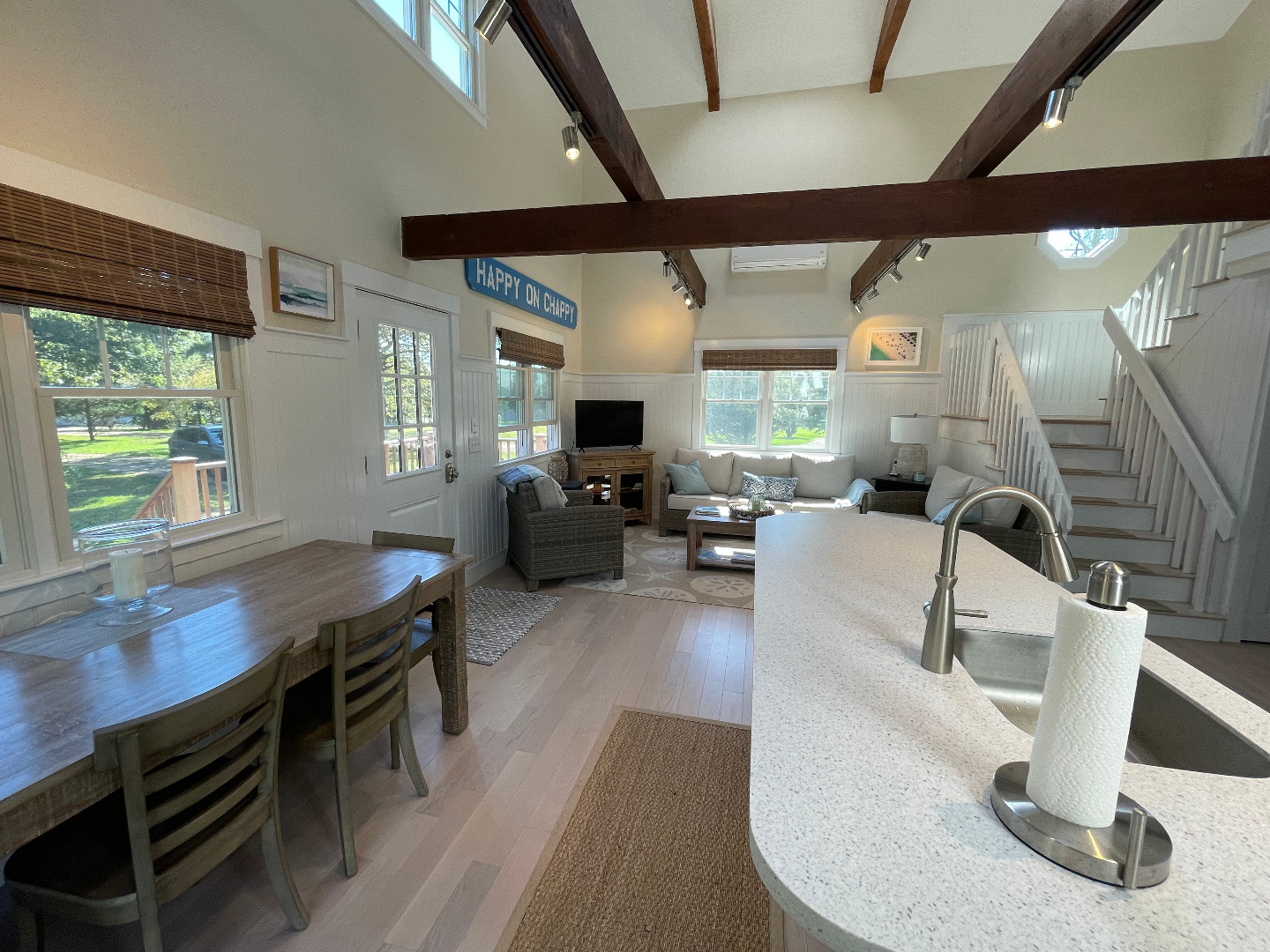 300 Chappaquiddick Road Edgartown, MA 02539 - Photo 7 of 16 a living room with furniture a wooden floor and a large window