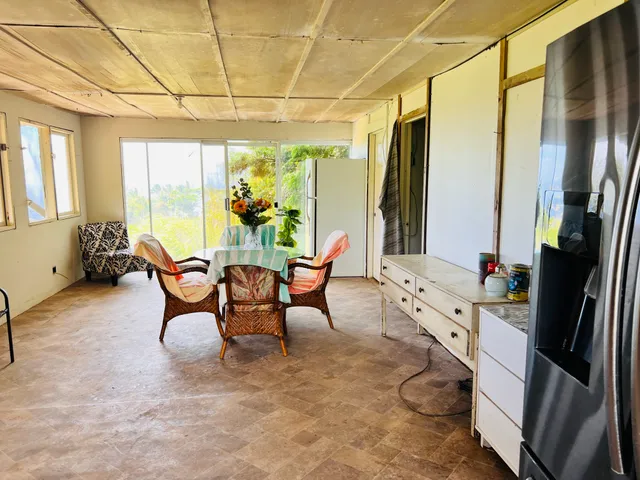 a dining room with furniture and a floor to ceiling window