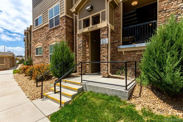 a view of a house with backyard and sitting area