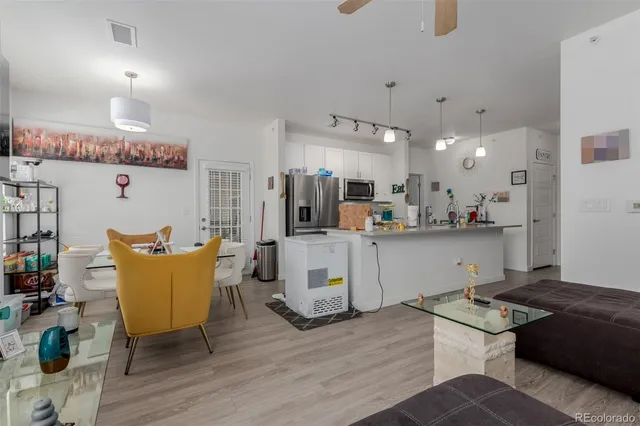 a living room with kitchen island furniture and a wooden floor
