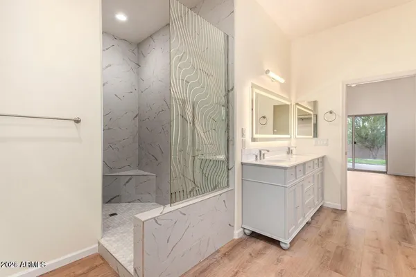 a bathroom with a double vanity sink toilet and shower