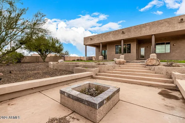 a view of a house with backyard porch and sitting area