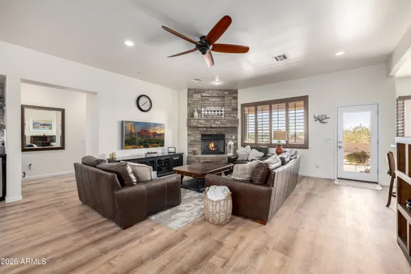a living room with fireplace furniture and a large window