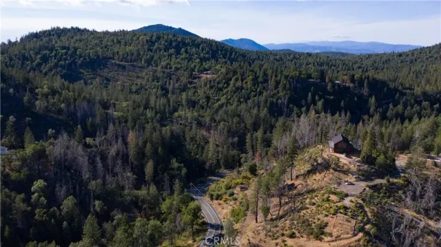 a view of a houses with a lush green hillside