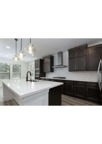 a kitchen with granite countertop a stove and cabinets
