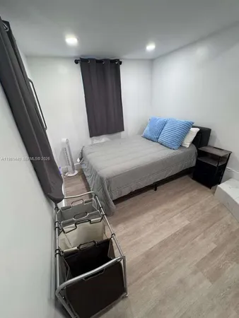 a bed sitting in a bedroom next to a window
