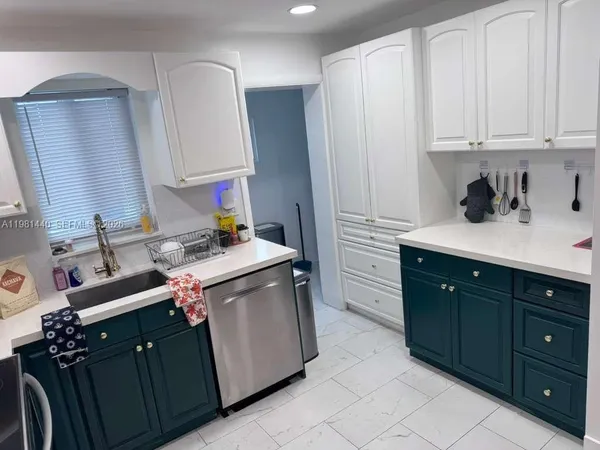 a kitchen with a sink and cabinets