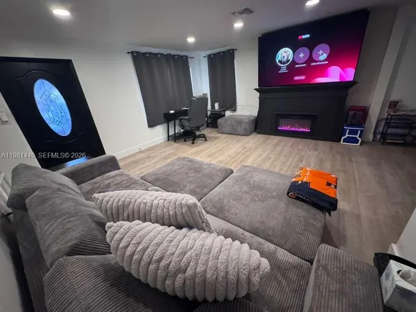 a living room with furniture and a flat screen tv
