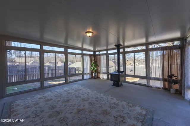 a view of a blue house with a yard and a table