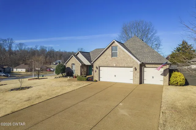 a view of residential houses with yard and mountain view in back