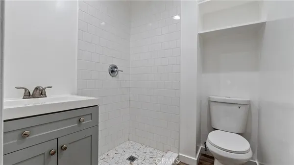 a white toilet sitting next to a bathroom sink