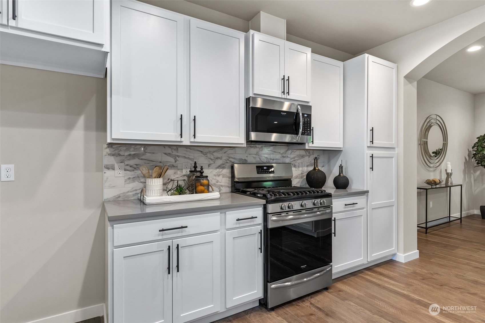 712 Stitch Road Lake Stevens, WA 98258 - Photo 11 of 39 a kitchen with stainless steel appliances granite countertop a stove a sink and a microwave
