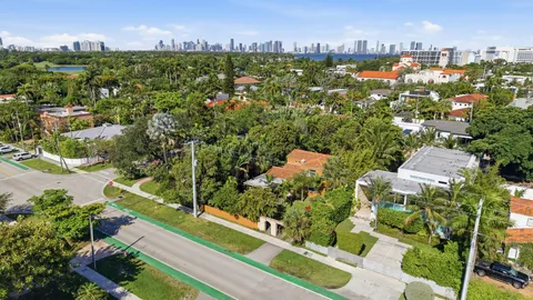 an aerial view of residential houses with outdoor space and street view