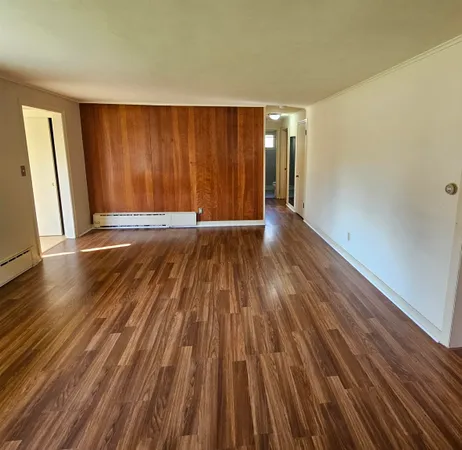 a spacious bedroom with a bed and a window