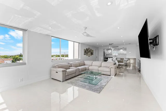 a living room with furniture wooden floor and a flat screen tv