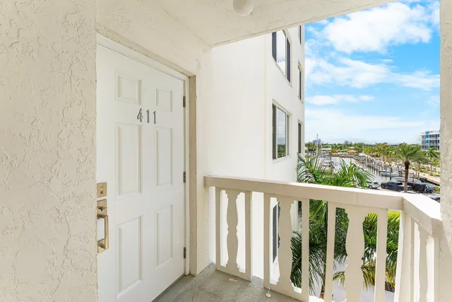 a view of a balcony with wooden floor and fence
