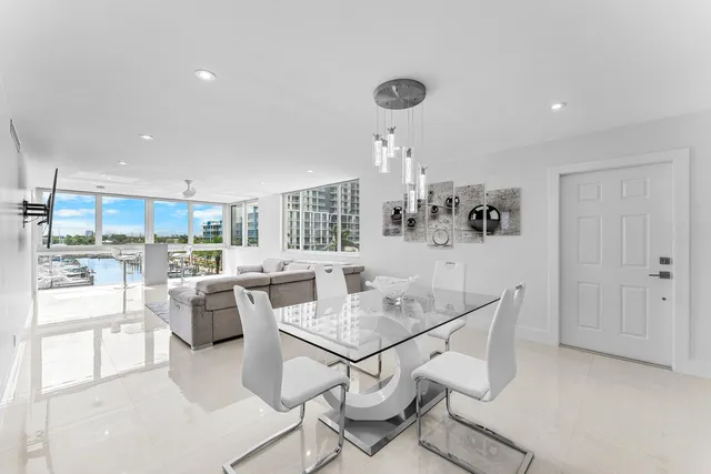 a kitchen with stainless steel appliances a stove a table and chairs
