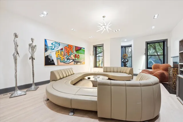 a living room with furniture and a floor to ceiling window