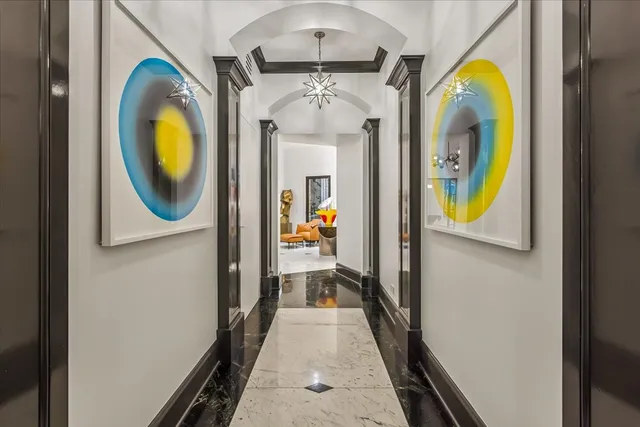 a living room with furniture and a chandelier