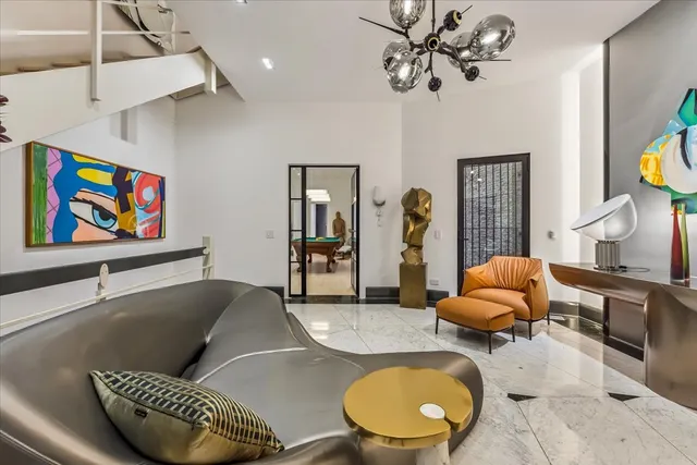a living room with furniture and a chandelier