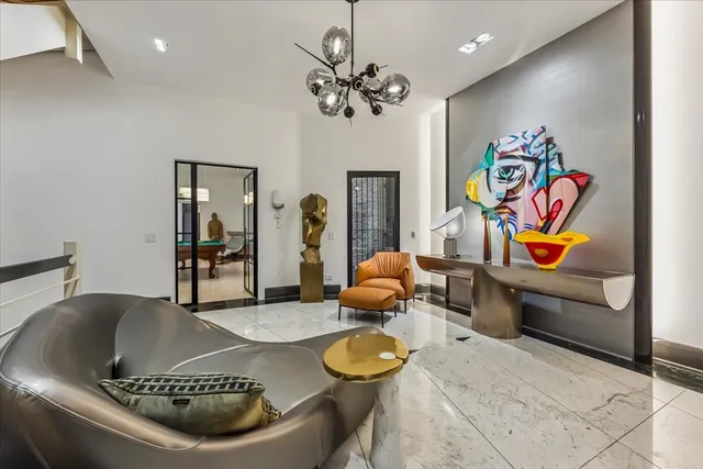 a bedroom with furniture and a chandelier