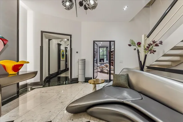 a living room with furniture a pool table and a fireplace