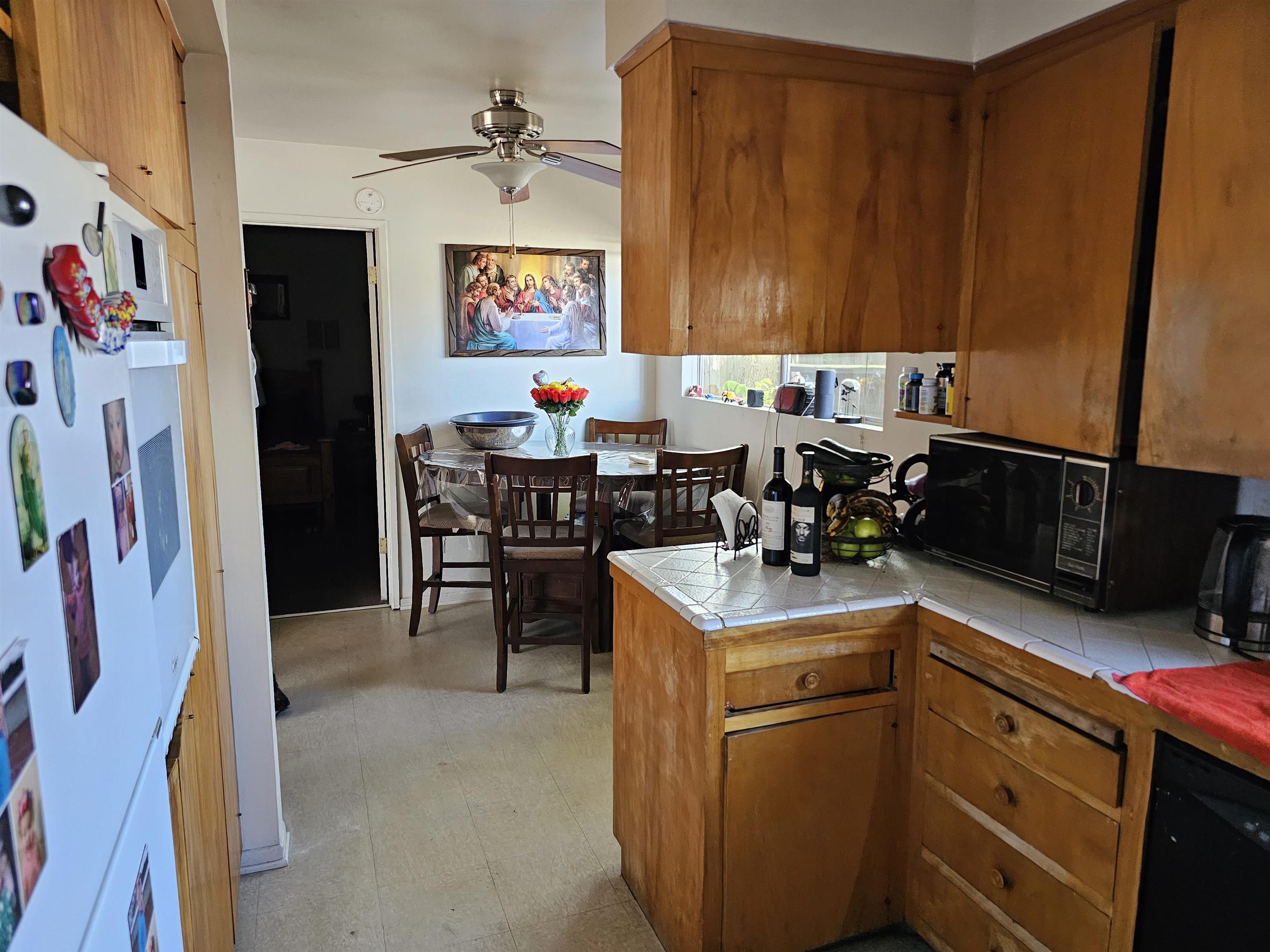 363 Short Street Bishop, CA 93514 - Photo 15 of 17 Functional kitchen space featuring wood cabinetry, tile countertops, and ample overhead storage