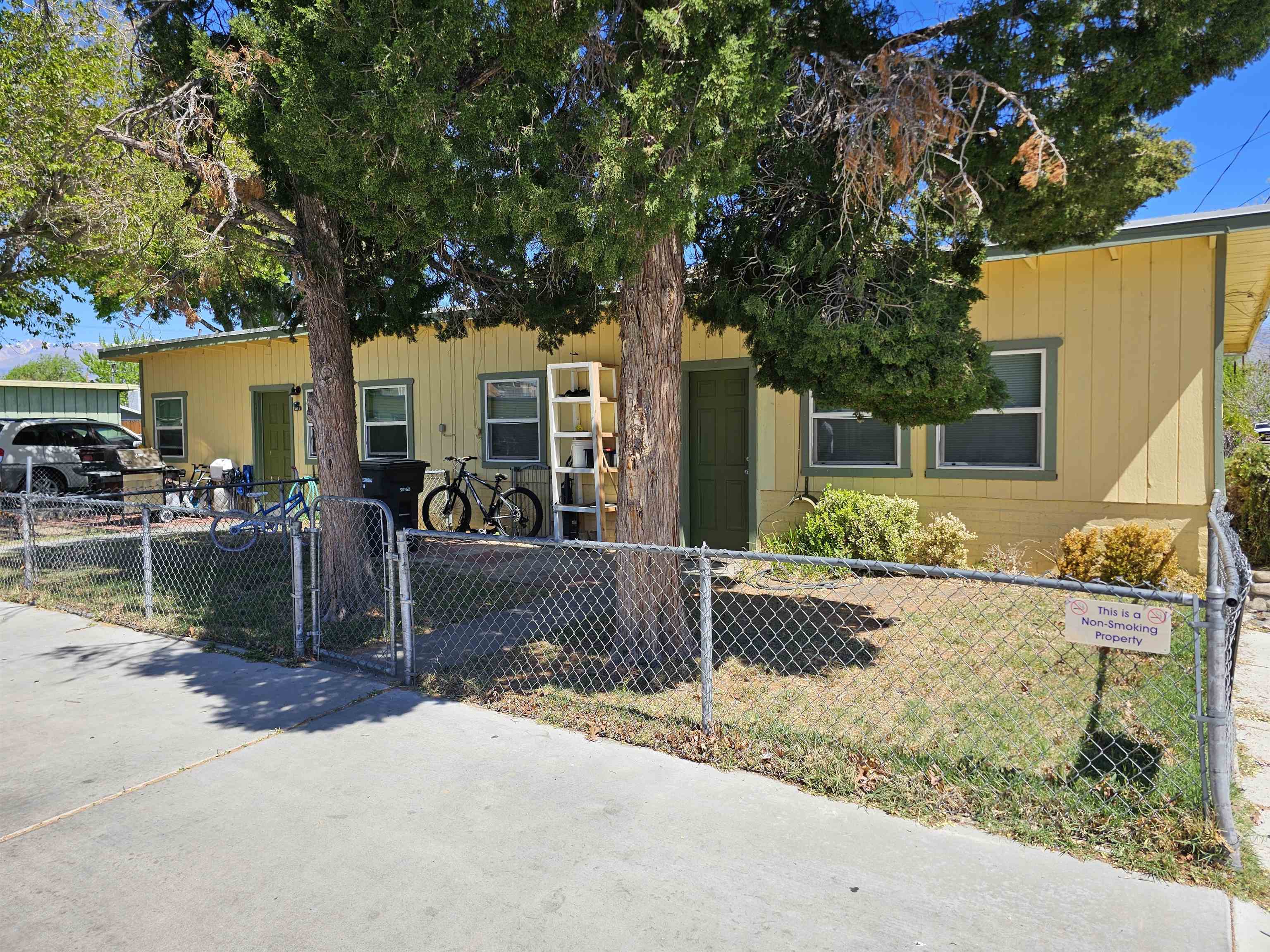 363 Short Street Bishop, CA 93514 - Photo 4 of 17 Yellow exterior siding with multiple windows and a front entry door