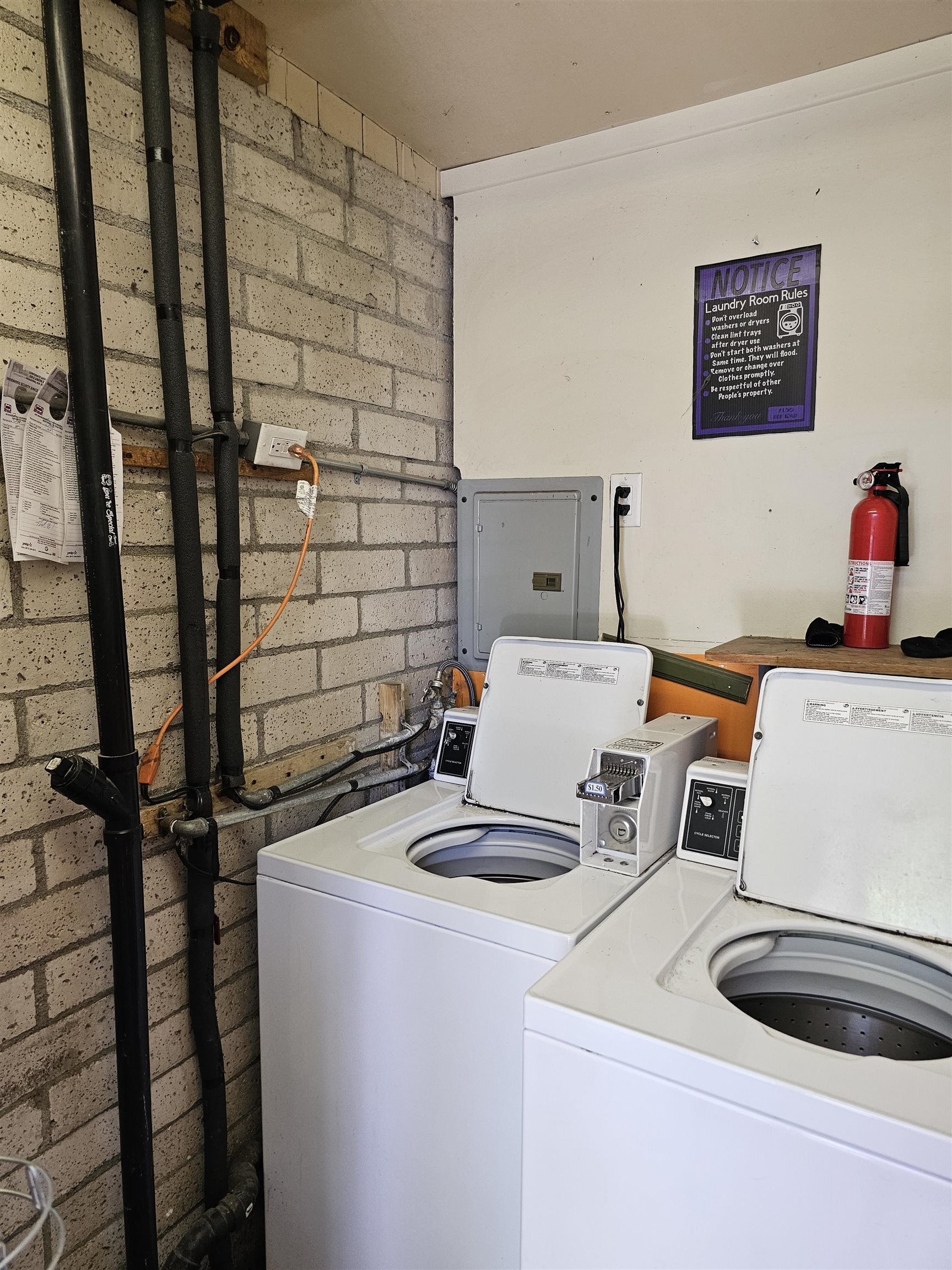 363 Short Street Bishop, CA 93514 - Photo 9 of 17 Laundry area featuring two white top-loading washing machines with coin-operated mechanisms