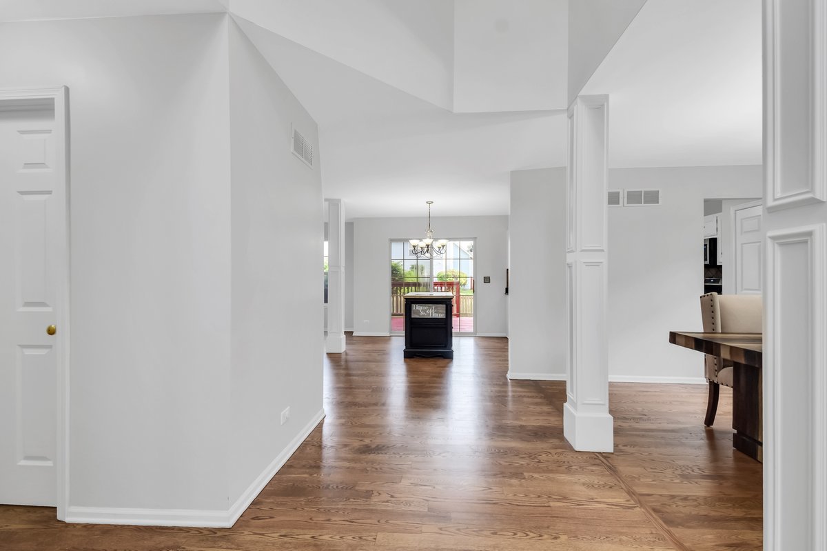 3420 Parliament Lane Naperville, IL 60564 - Photo 12 of 47 a view of a hallway view of living room with wooden floor