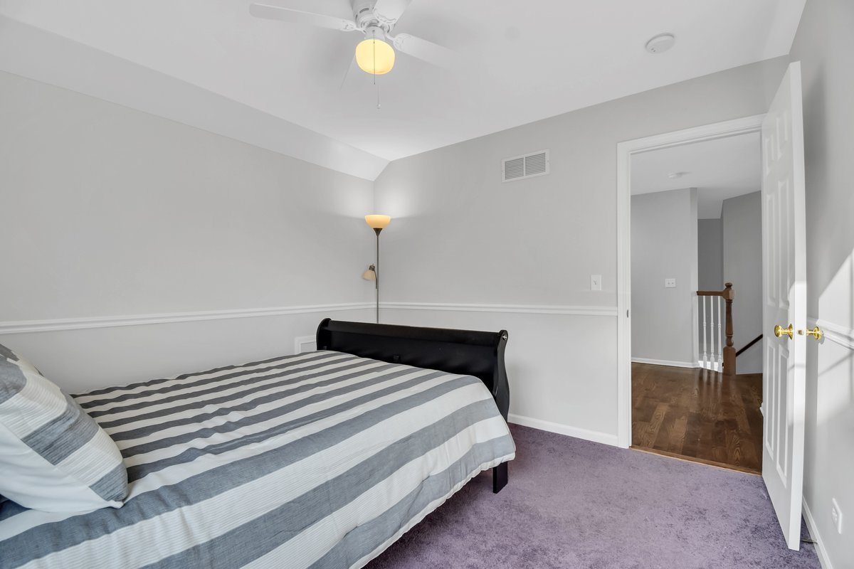 3420 Parliament Lane Naperville, IL 60564 - Photo 18 of 47 a bedroom with a bed and a lamp
