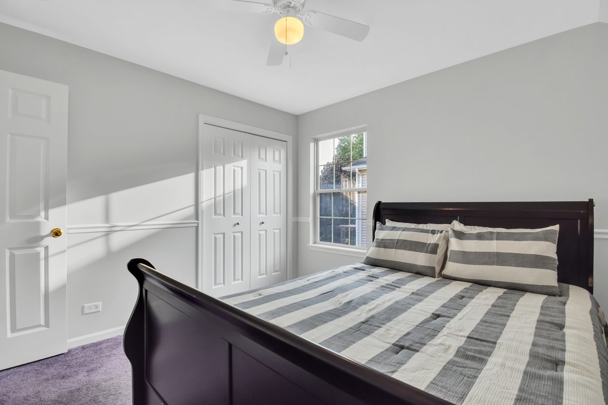3420 Parliament Lane Naperville, IL 60564 - Photo 19 of 47 a bedroom with a bed and a book shelf