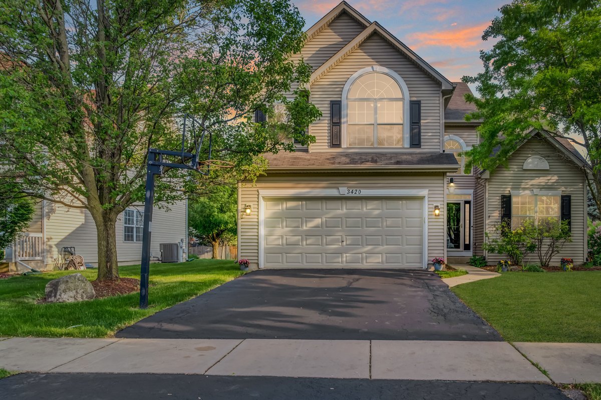 3420 Parliament Lane Naperville, IL 60564 - Photo 2 of 47 a front view of a house with a yard and garage