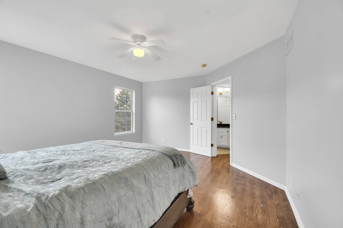 3420 Parliament Lane Naperville, IL 60564 - Photo 27 of 47 a spacious bedroom with a bed and a window