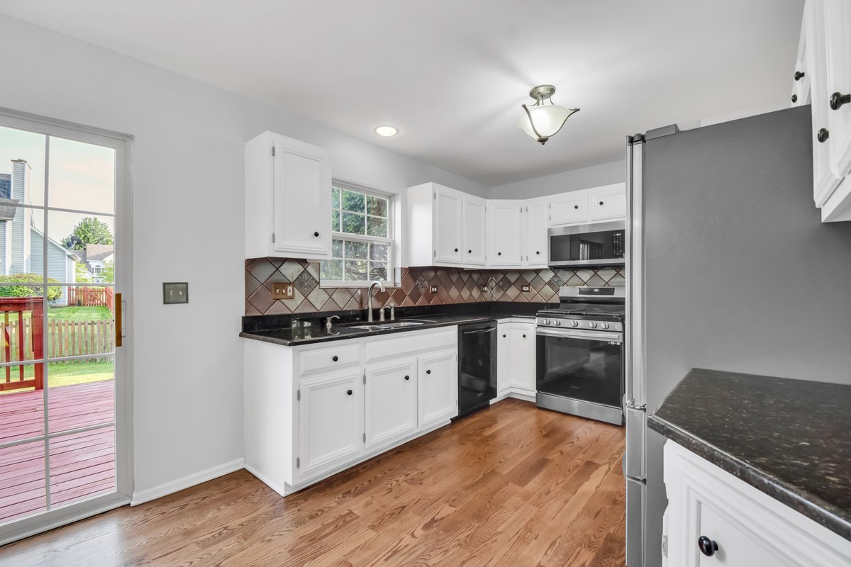 3420 Parliament Lane Naperville, IL 60564 - Photo 30 of 47 a kitchen with granite countertop a stove a sink and a refrigerator