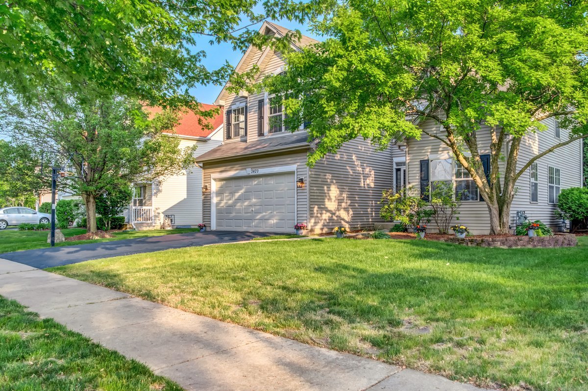 3420 Parliament Lane Naperville, IL 60564 - Photo 3 of 47 a front view of a house with a garden and tree