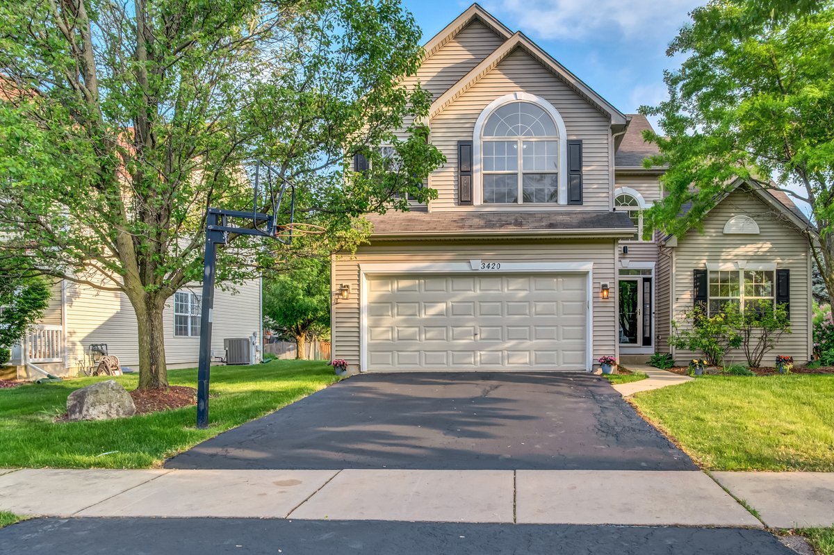 3420 Parliament Lane Naperville, IL 60564 - Photo 31 of 47 a front view of a house with a yard and garage