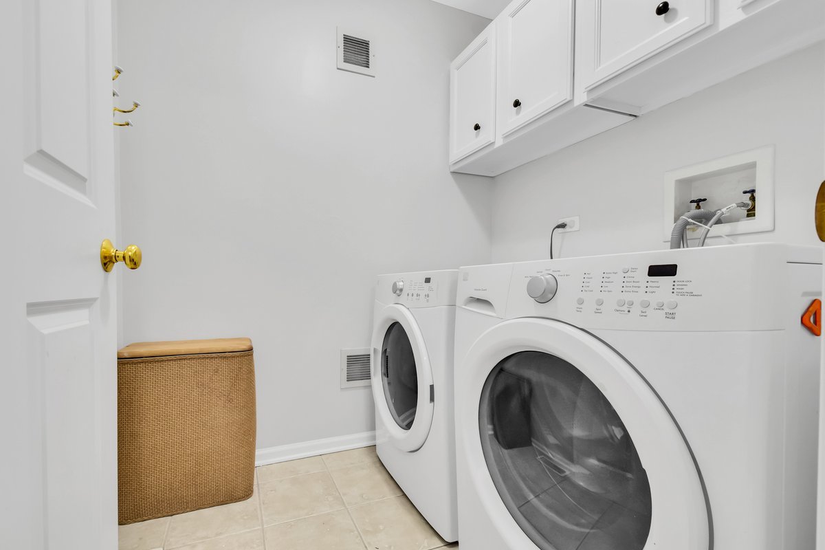 3420 Parliament Lane Naperville, IL 60564 - Photo 37 of 47 a view of washer and dryer with kitchen in the background