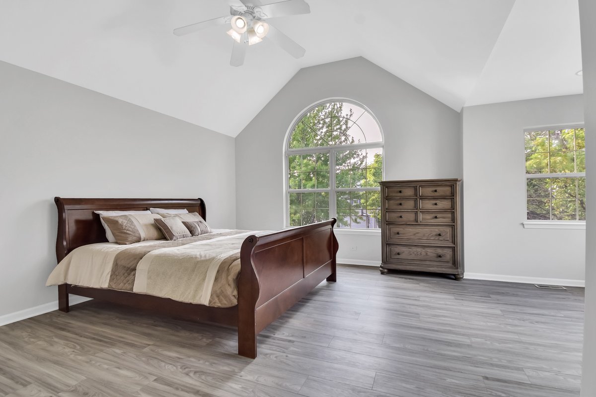 3420 Parliament Lane Naperville, IL 60564 - Photo 40 of 47 a spacious bedroom with a bed and a large window