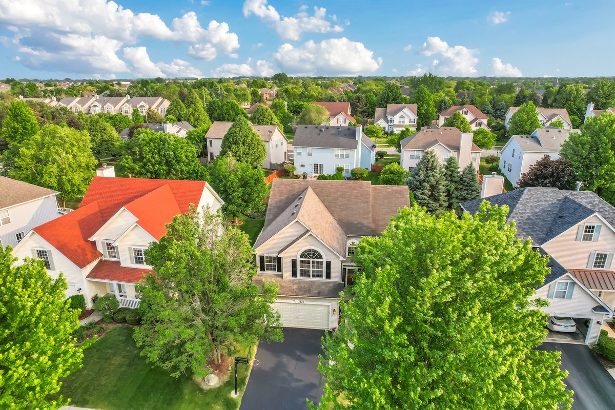 3420 Parliament Lane Naperville, IL 60564 - Photo 9 of 47 an aerial view of a house with a yard and outdoor seating