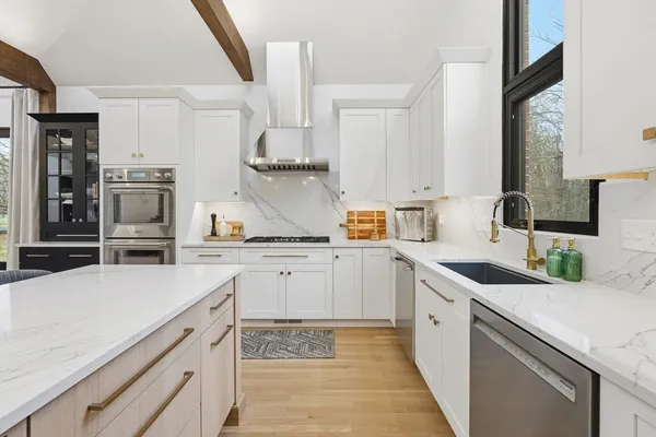 a kitchen with a sink stove and cabinets