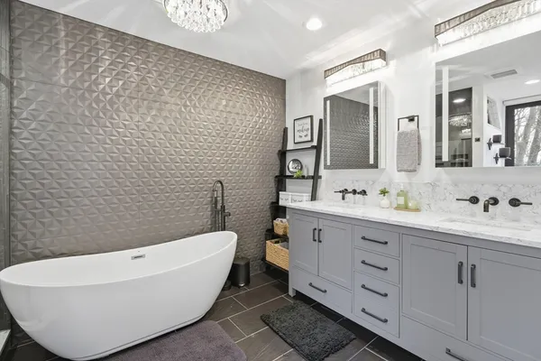 a bathroom with a bathtub sink mirror and toilet
