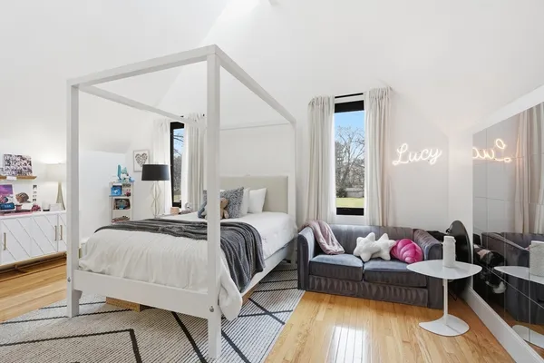 a bedroom with a bed and wooden floor