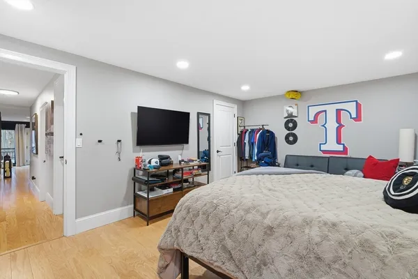 a bedroom with furniture and a flat screen tv