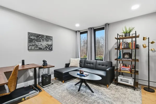 a living room with furniture a rug and a window