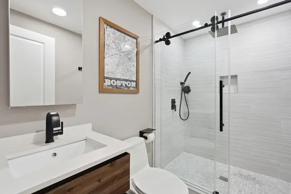a bathroom with a sink toilet and shower